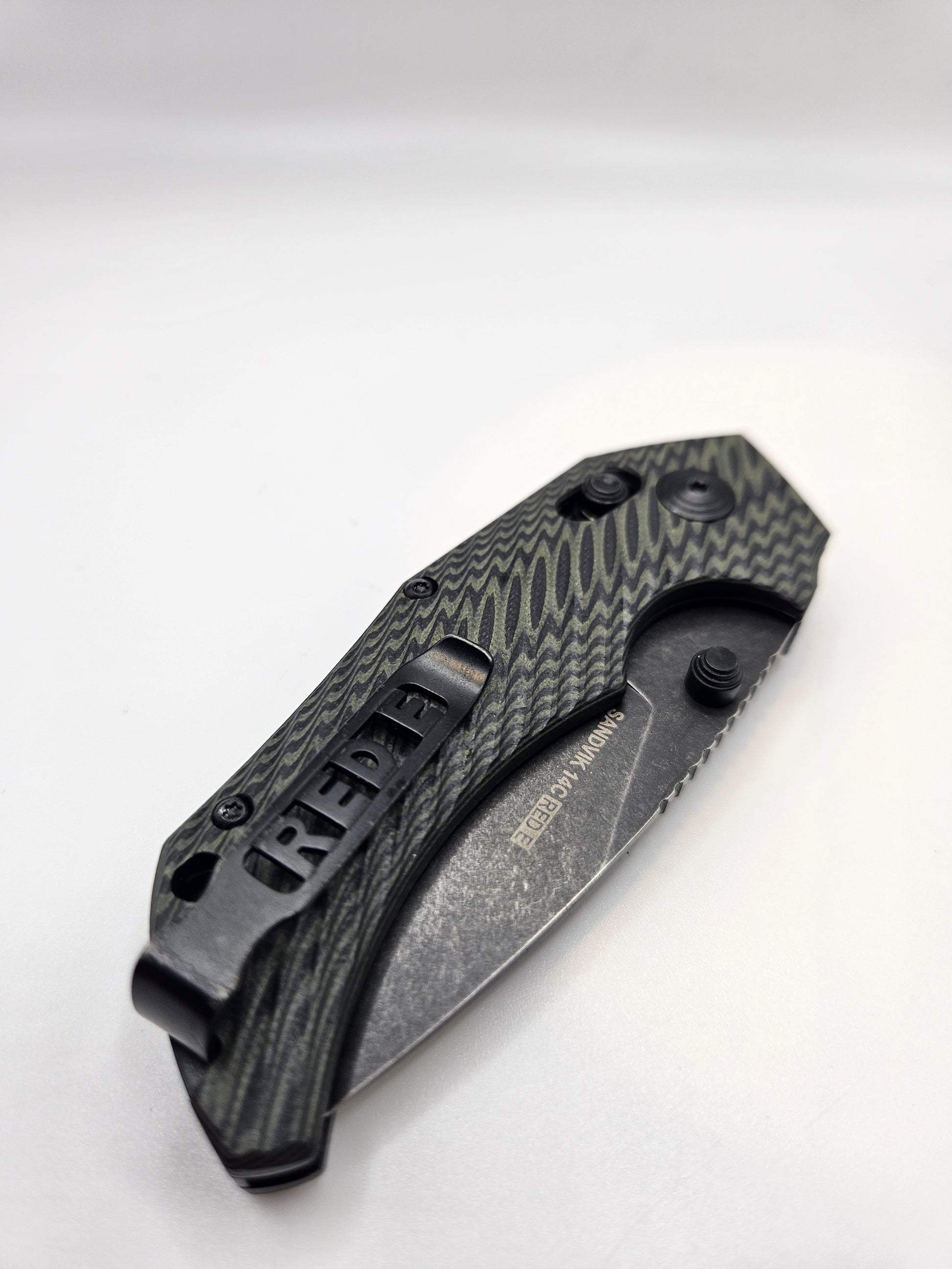 Folding knife with textured handle on a white background